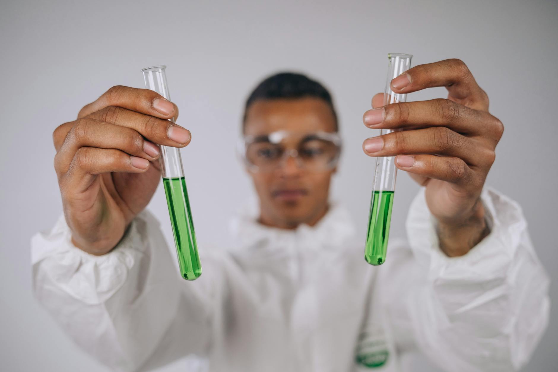 a man holding test tubes